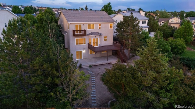 4839 Spotted Horse Dr, Colorado Springs, CO 80923 - back of property featuring a balcony, stairway, stucco siding, and a patio