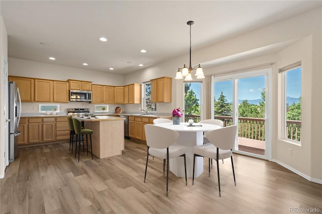 4839 Spotted Horse Dr, Colorado Springs, CO 80923 - kitchen with appliances with stainless steel finishes, a center island, light wood-style floors, light countertops, and recessed lighting