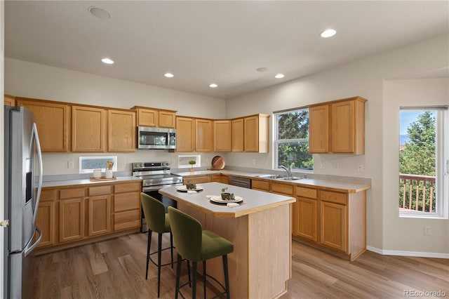 4839 Spotted Horse Dr, Colorado Springs, CO 80923 - kitchen with stainless steel appliances, light countertops, light wood finished floors, a kitchen island, and recessed lighting