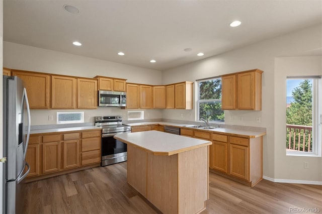 4839 Spotted Horse Dr, Colorado Springs, CO 80923 - kitchen featuring stainless steel appliances, light countertops, wood finished floors, a kitchen island, and recessed lighting