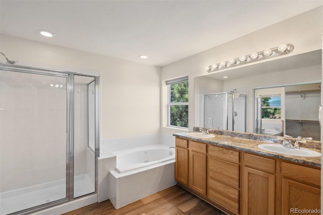 4839 Spotted Horse Dr, Colorado Springs, CO 80923 - full bathroom featuring a shower stall, double vanity, a whirlpool tub, wood finished floors, and recessed lighting