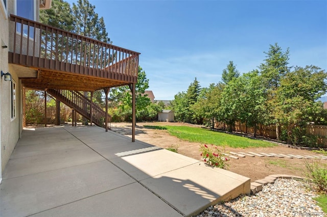 4839 Spotted Horse Dr, Colorado Springs, CO 80923 - fenced backyard with a patio area, a wooden deck, stairs, and an outbuilding