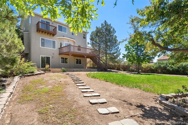 4839 Spotted Horse Dr, Colorado Springs, CO 80923 - back of house featuring stairway, a balcony, stucco siding, and a wooden deck