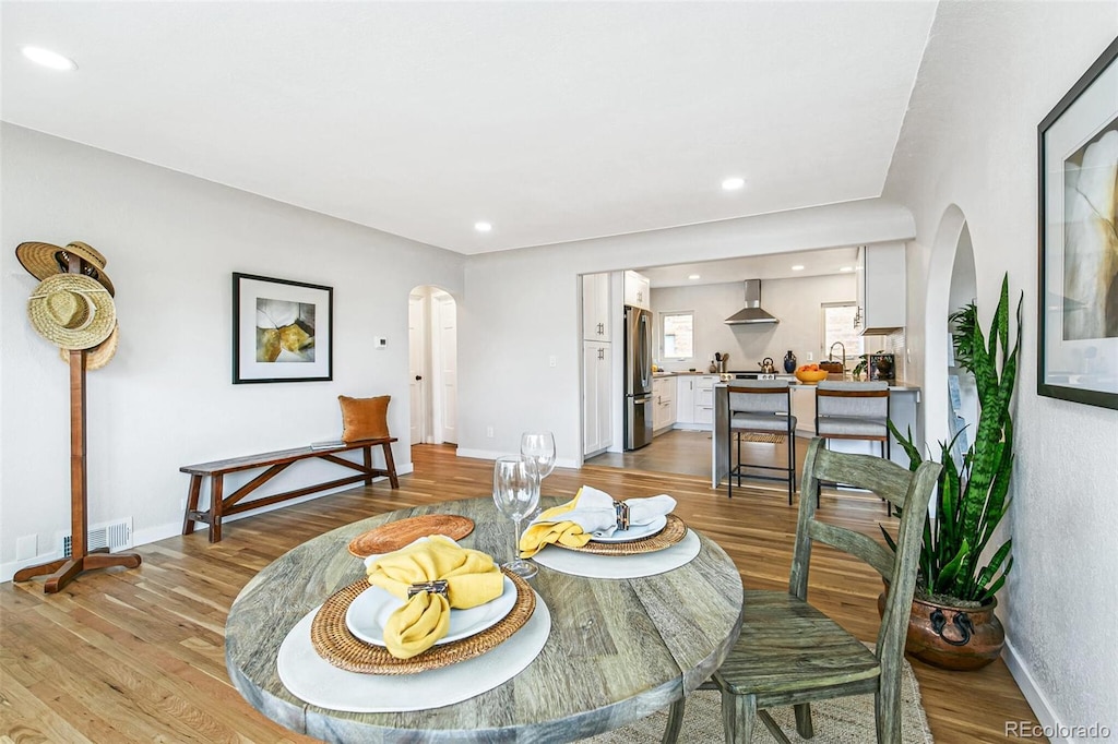 dining room featuring light wood-type flooring and sink