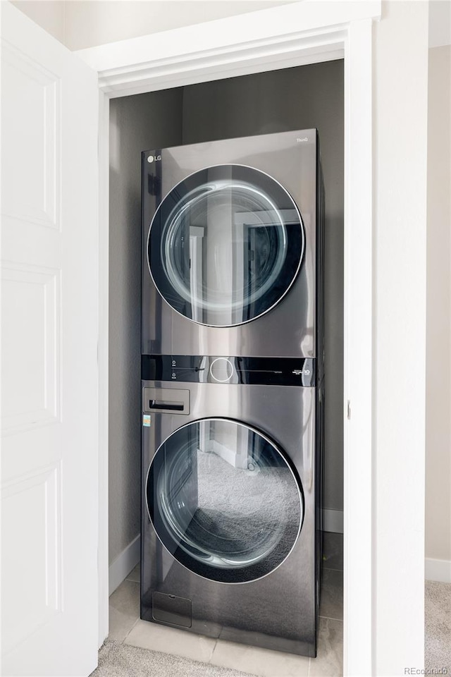 6307 Dayton Ct, Denver, CO 80238 - washroom featuring stacked washing machine and dryer and baseboards
