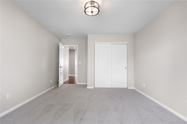 23870 E Dorado Pl, Aurora, CO 80016 - unfurnished bedroom featuring a closet, baseboards, and carpet flooring