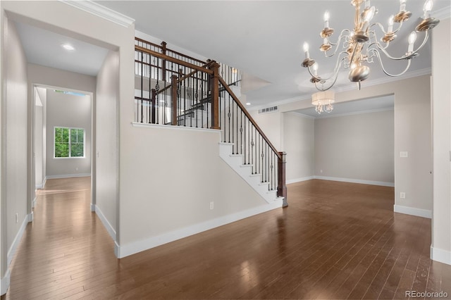 23870 E Dorado Pl, Aurora, CO 80016 - stairs with wood-type flooring, a chandelier, baseboards, and crown molding