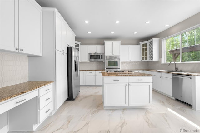 23870 E Dorado Pl, Aurora, CO 80016 - kitchen with appliances with stainless steel finishes, a sink, recessed lighting, glass insert cabinets, and tasteful backsplash