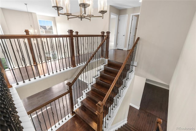 23870 E Dorado Pl, Aurora, CO 80016 - staircase with a chandelier, wood finished floors, and baseboards