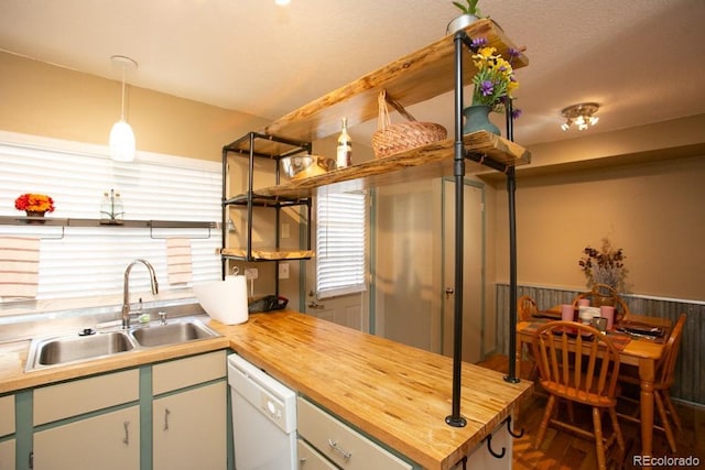 kitchen with open shelves, wainscoting, a sink, butcher block countertops, and dishwasher