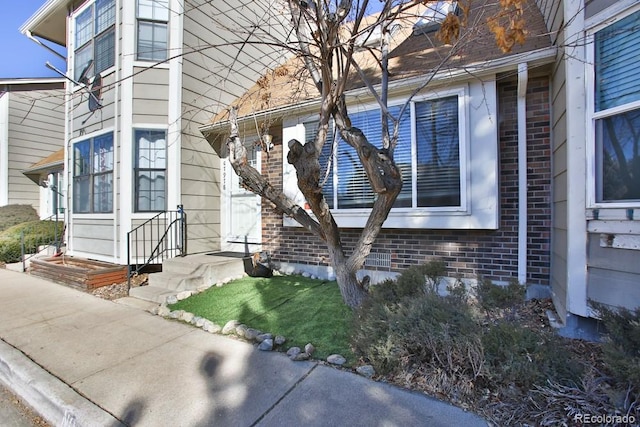 view of home's exterior with brick siding