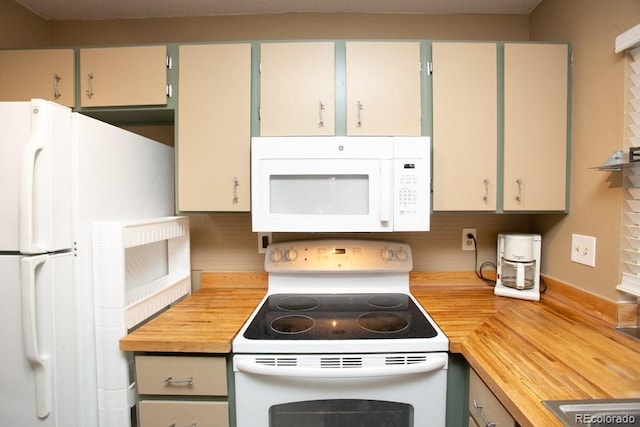 kitchen with white appliances, wood counters, and backsplash