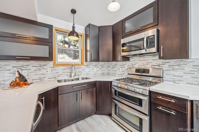 7350 Timber Trail Rd, Evergreen, CO 80439 - kitchen with appliances with stainless steel finishes, a sink, light countertops, and dark brown cabinets
