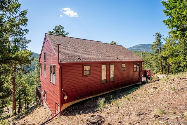 7350 Timber Trail Rd, Evergreen, CO 80439 - view of side of property with a shingled roof and a mountain view
