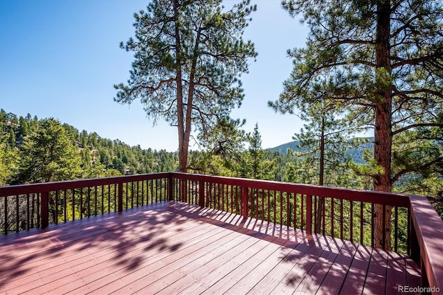 7350 Timber Trail Rd, Evergreen, CO 80439 - deck featuring a wooded view
