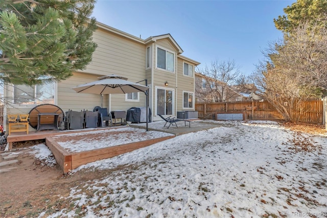 view of snow covered back of property