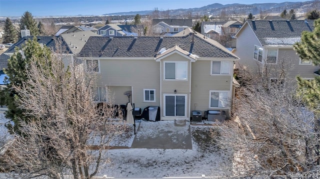 back of property featuring a mountain view and central AC unit