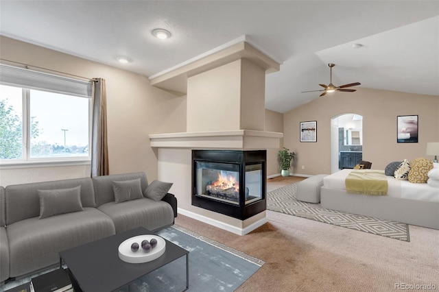 12047 W Coal Mine Dr, Littleton, CO 80127 - carpeted bedroom with vaulted ceiling, arched walkways, a multi sided fireplace, and baseboards