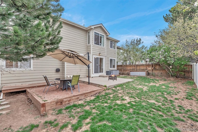 12047 W Coal Mine Dr, Littleton, CO 80127 - rear view of house featuring a yard, a patio, and a fenced backyard