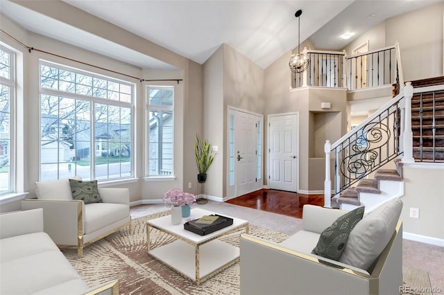 12047 W Coal Mine Dr, Littleton, CO 80127 - carpeted living area featuring an inviting chandelier, a wealth of natural light, baseboards, and stairs