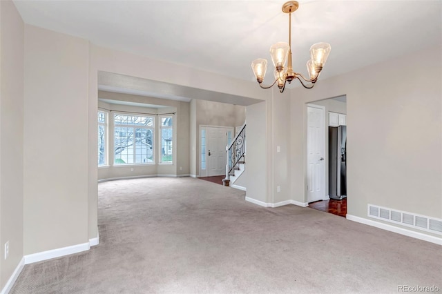 12047 W Coal Mine Dr, Littleton, CO 80127 - empty room with a notable chandelier, carpet floors, baseboards, and visible vents
