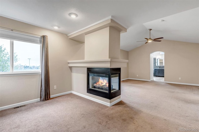 12047 W Coal Mine Dr, Littleton, CO 80127 - unfurnished living room featuring carpet, a multi sided fireplace, visible vents, and ceiling fan