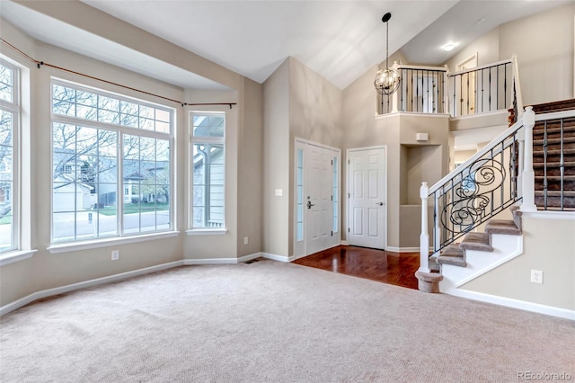 12047 W Coal Mine Dr, Littleton, CO 80127 - foyer entrance with a wealth of natural light, a chandelier, baseboards, and carpet floors