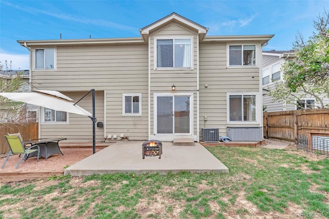 12047 W Coal Mine Dr, Littleton, CO 80127 - back of house with a fire pit, a yard, a patio, a fenced backyard, and central AC unit