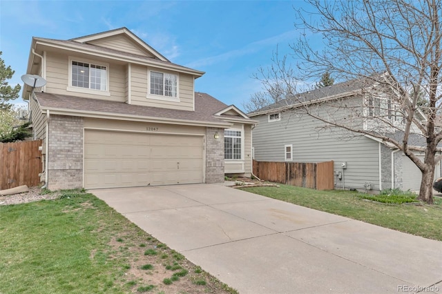 12047 W Coal Mine Dr, Littleton, CO 80127 - view of front of house featuring fence, an attached garage, brick siding, driveway, and a front yard