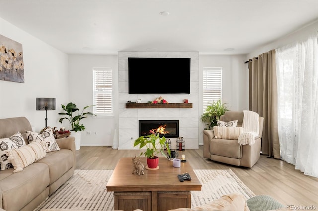 27986 E Frost Pl, Aurora, CO 80016 - living area featuring light wood finished floors and a tile fireplace