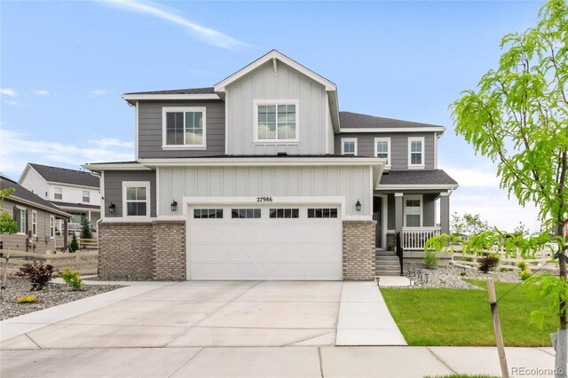 27986 E Frost Pl, Aurora, CO 80016 - craftsman house with brick siding, an attached garage, a porch, board and batten siding, and driveway
