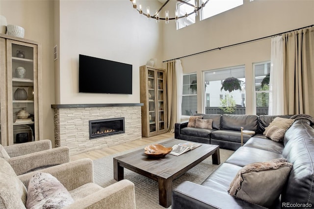 11142 Bright Sky St, Littleton, CO 80125 - living room featuring a fireplace, a chandelier, wood finished floors, and a high ceiling