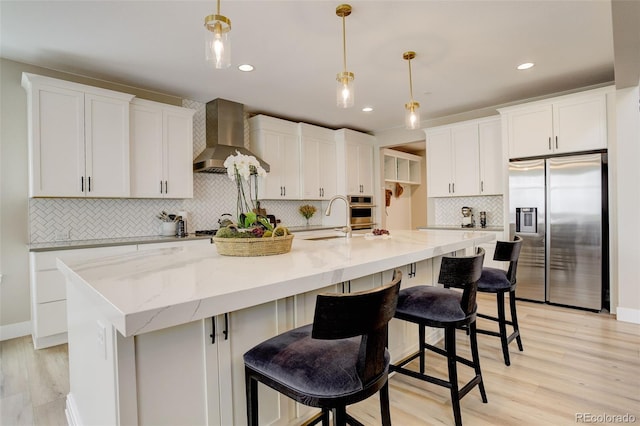 11142 Bright Sky St, Littleton, CO 80125 - kitchen with appliances with stainless steel finishes, wall chimney exhaust hood, white cabinets, tasteful backsplash, and recessed lighting
