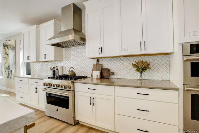 11142 Bright Sky St, Littleton, CO 80125 - kitchen featuring wall chimney exhaust hood, appliances with stainless steel finishes, white cabinetry, and tasteful backsplash