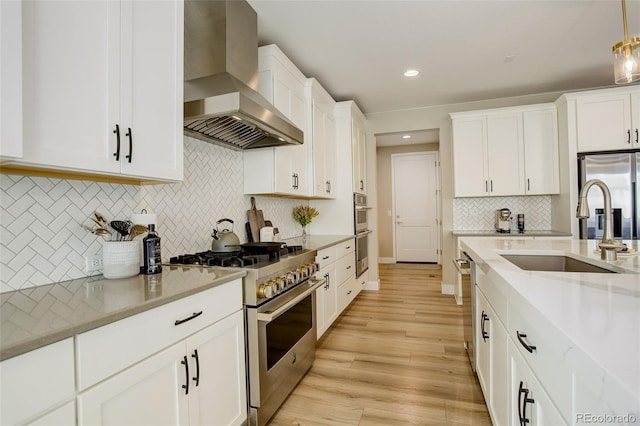11142 Bright Sky St, Littleton, CO 80125 - kitchen with wall chimney exhaust hood, stainless steel appliances, a sink, tasteful backsplash, and white cabinetry