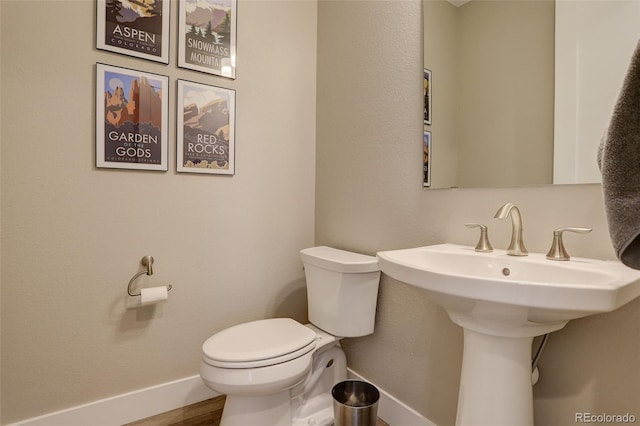 11142 Bright Sky St, Littleton, CO 80125 - half bathroom with toilet, baseboards, and wood finished floors