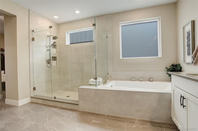11142 Bright Sky St, Littleton, CO 80125 - full bath featuring vanity, a stall shower, a garden tub, and recessed lighting