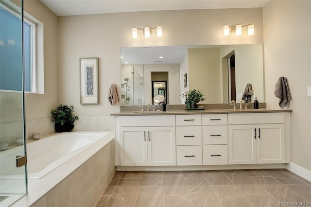 11142 Bright Sky St, Littleton, CO 80125 - full bath featuring double vanity, a bath, a stall shower, marble look tile flooring, and plenty of natural light