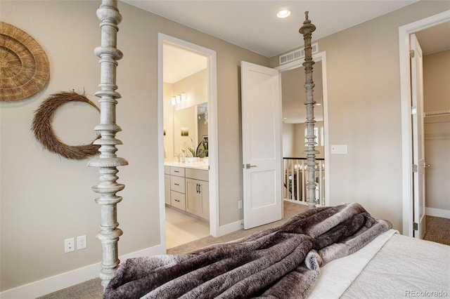 11142 Bright Sky St, Littleton, CO 80125 - bedroom with light colored carpet, ensuite bathroom, baseboards, and recessed lighting