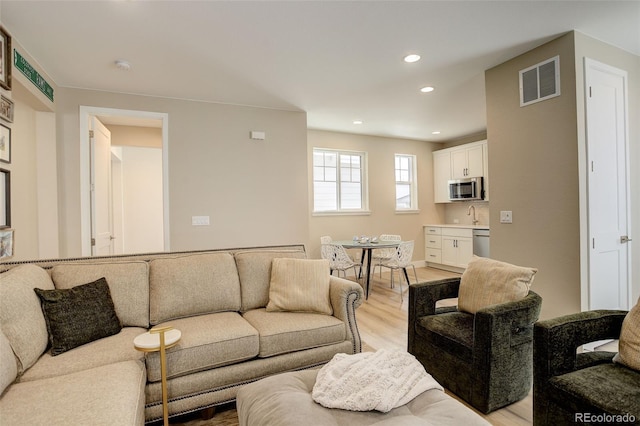 11142 Bright Sky St, Littleton, CO 80125 - living room featuring light wood finished floors and recessed lighting