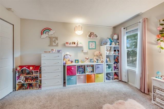 game room featuring carpet flooring and a textured ceiling