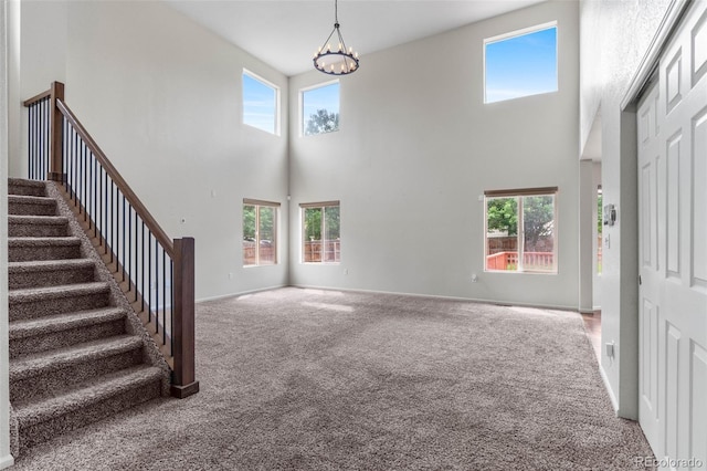 7171 Canyon Way, Frederick, CO 80504 - carpeted foyer featuring a towering ceiling, a chandelier, and stairway