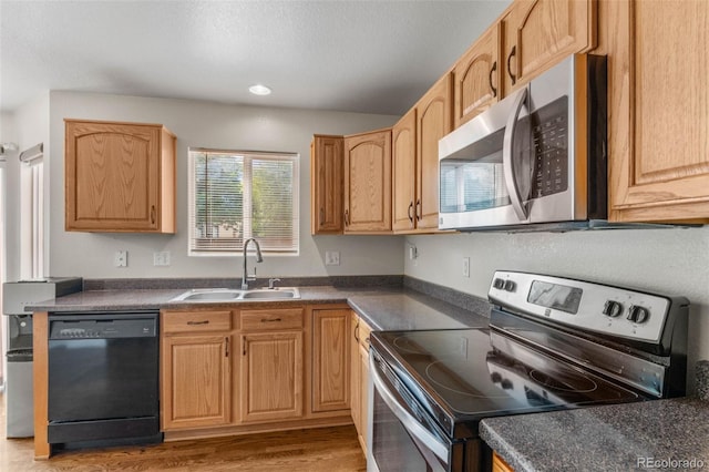 7171 Canyon Way, Frederick, CO 80504 - kitchen featuring stainless steel appliances, dark countertops, and light wood-style flooring
