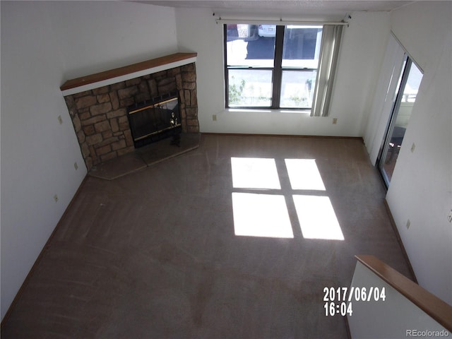 unfurnished living room with a stone fireplace