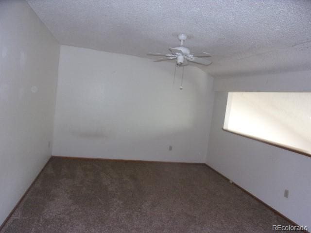 carpeted empty room featuring ceiling fan and a textured ceiling