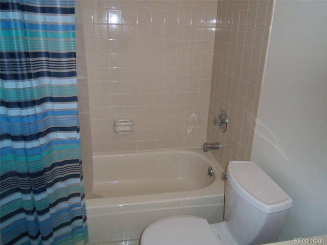 bathroom featuring shower / tub combo and toilet