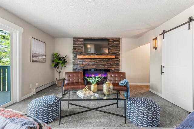 carpeted living room with a barn door, a textured ceiling, and a baseboard radiator