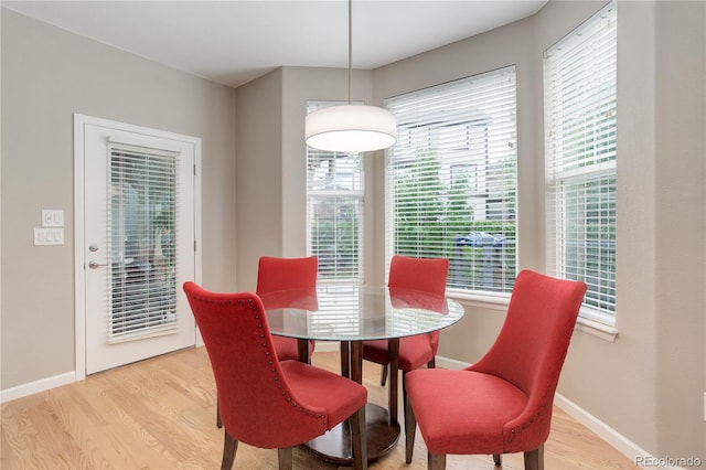 24686 E Florida Ave, Aurora, CO 80018 - dining space with light wood-style floors, healthy amount of natural light, and baseboards