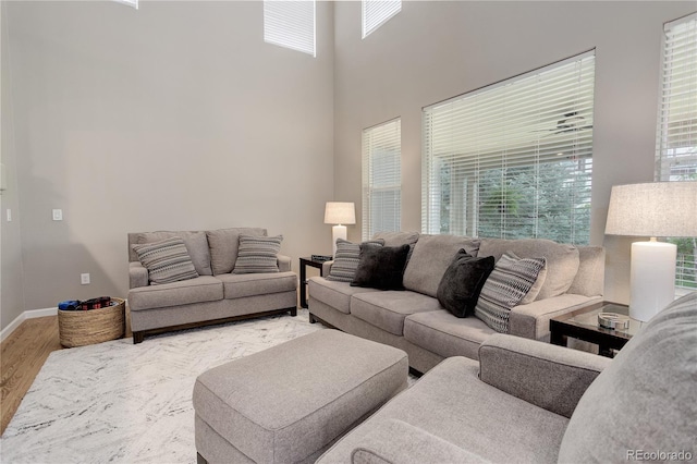 24686 E Florida Ave, Aurora, CO 80018 - living room featuring wood finished floors, baseboards, and a high ceiling