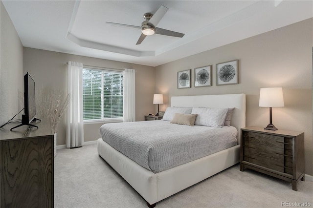 24686 E Florida Ave, Aurora, CO 80018 - bedroom featuring light colored carpet, a tray ceiling, baseboards, and a ceiling fan